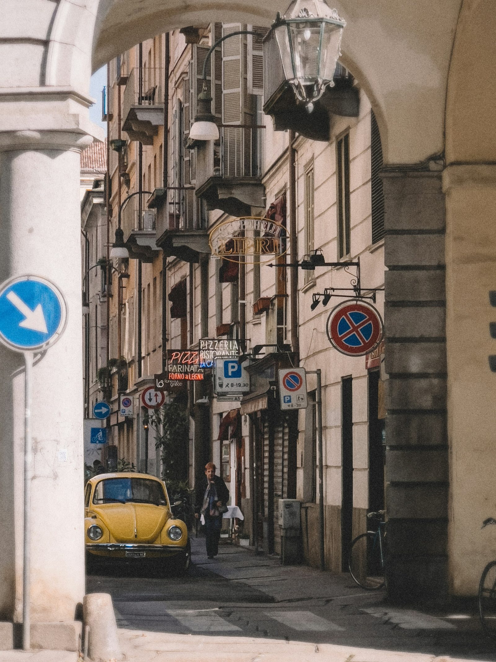 Een Italiaans steegje met een pijl die de weg wijst · Italiaanse grammatica B2