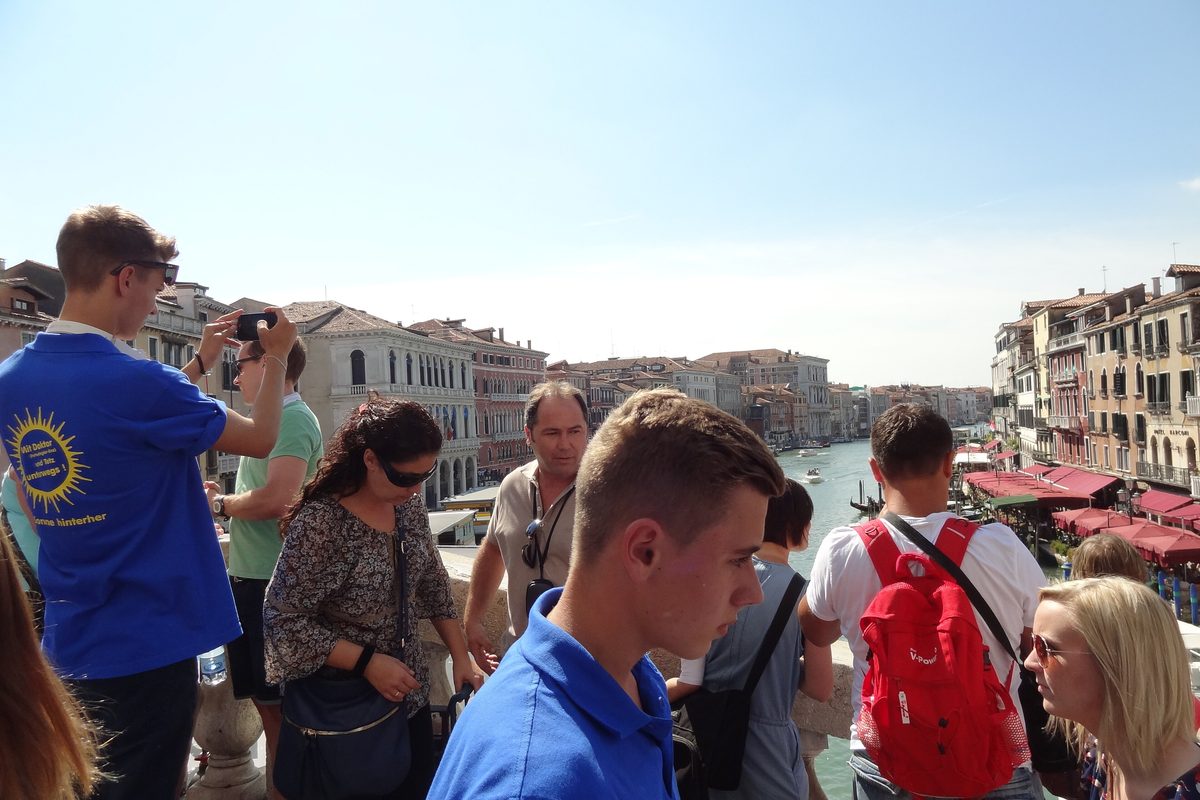 Tourists taking photos on the Rialto Bridge in Venice