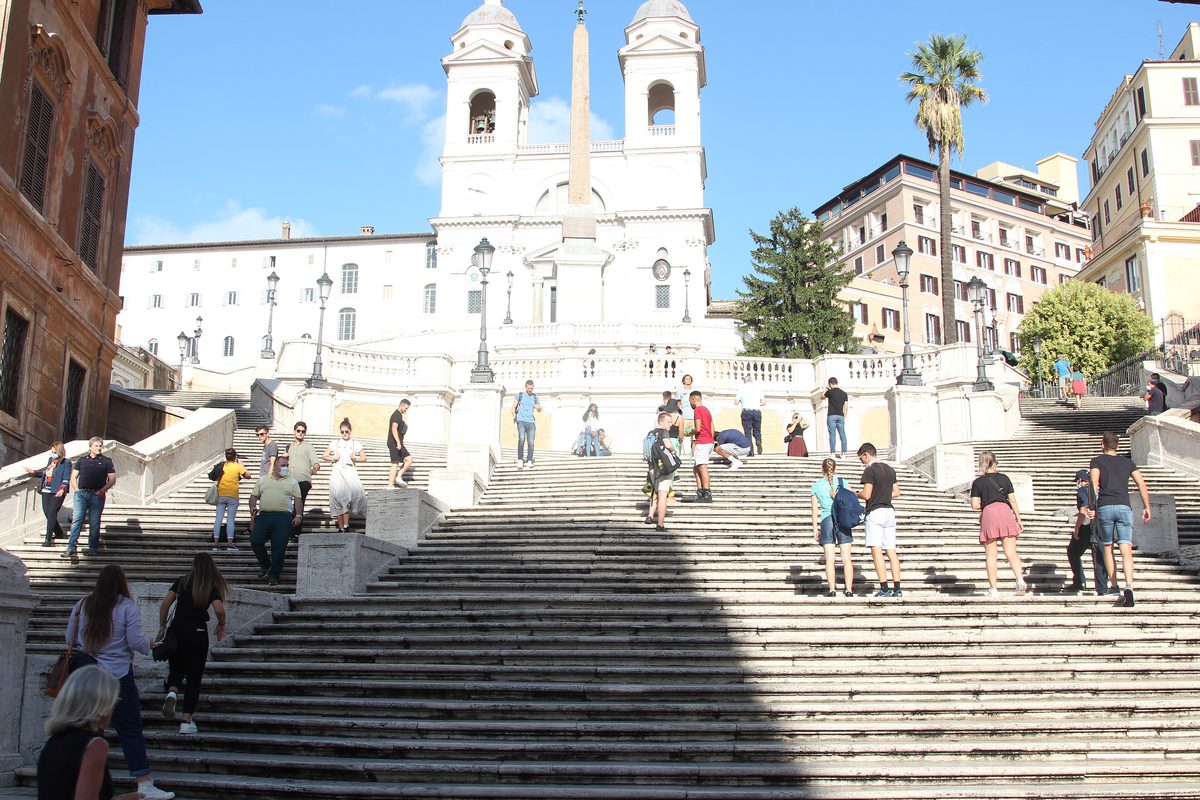 People walking up the Spanish Steps towards the church of Trinità dei Monti in Rome