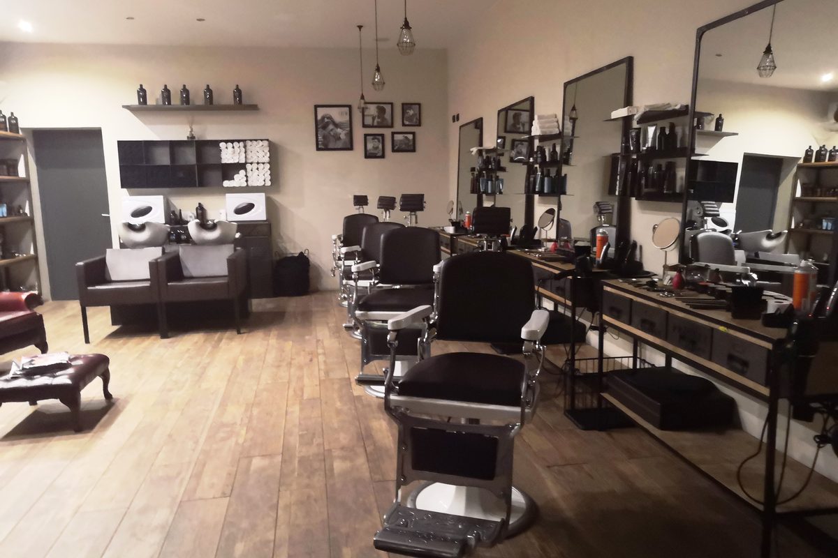 Classic barber chairs and mirrors in a barber shop in Lucca