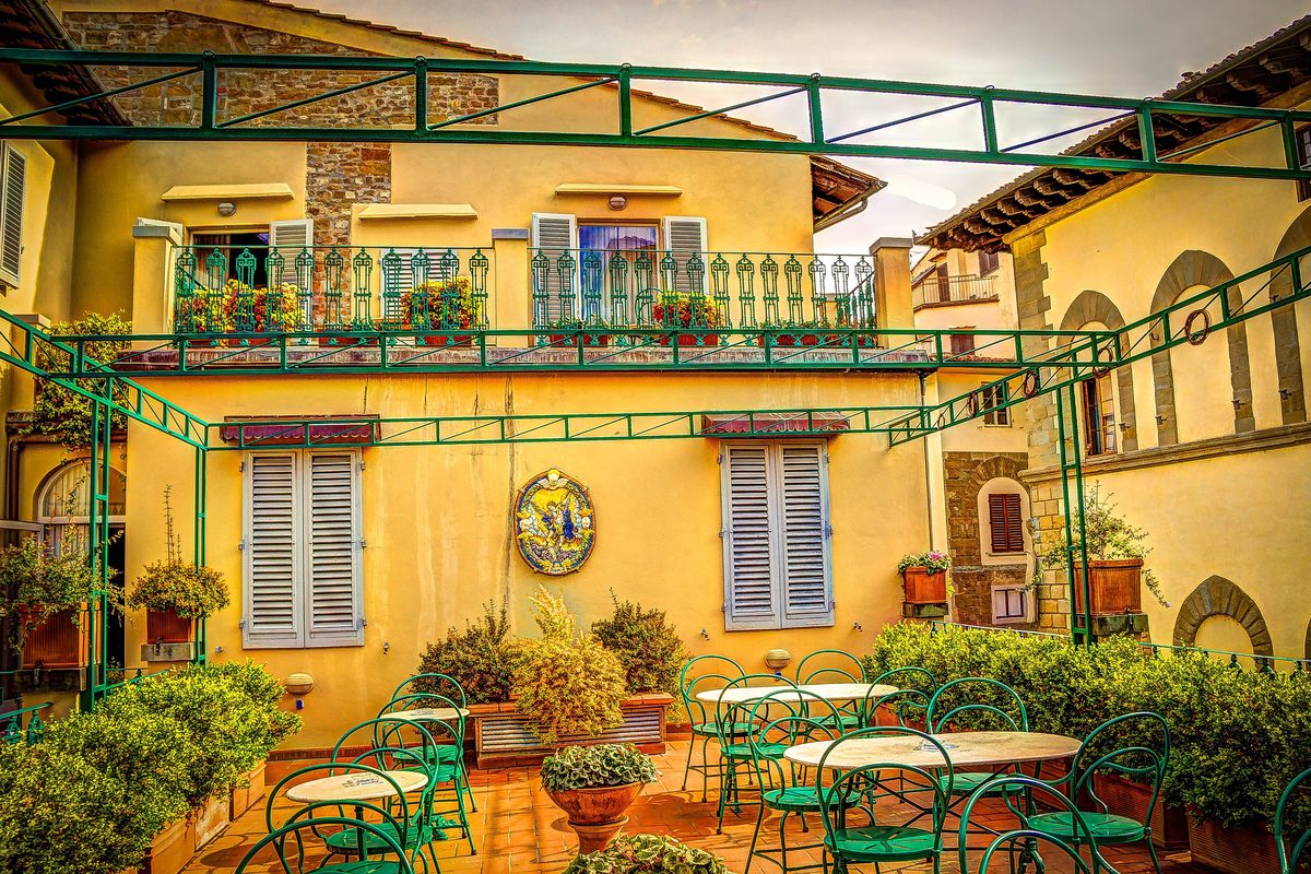 Courtyard with balconies and tables at a guesthouse in Florence