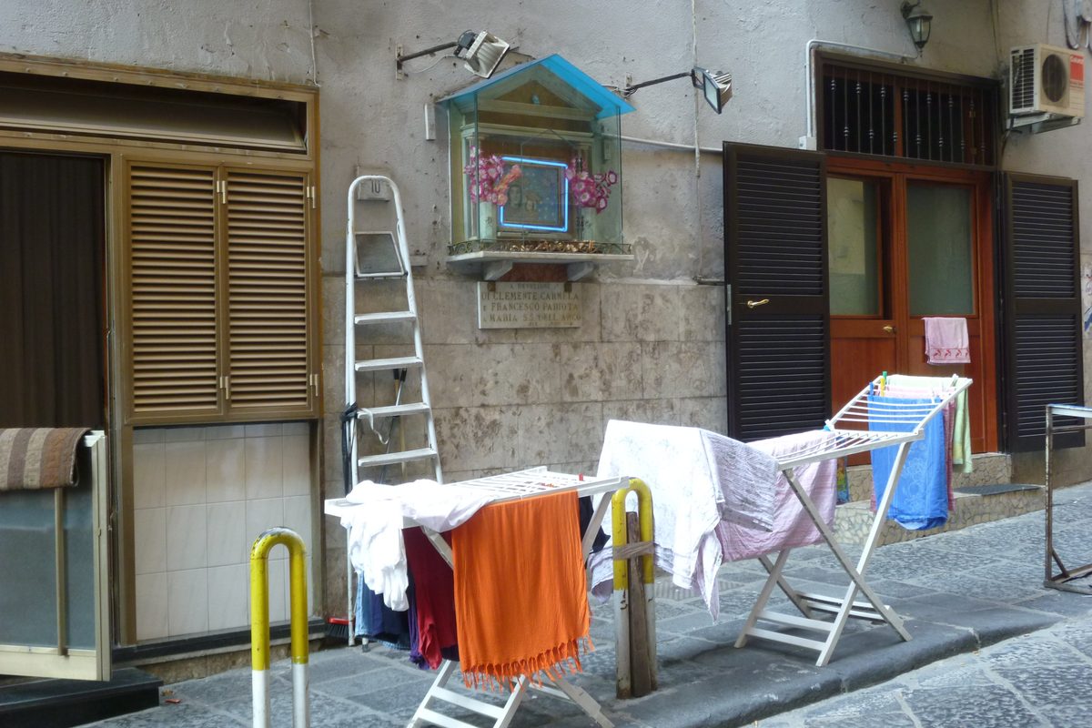 Laundry drying on a rack outside a ground-floor home, a basso, in Naples