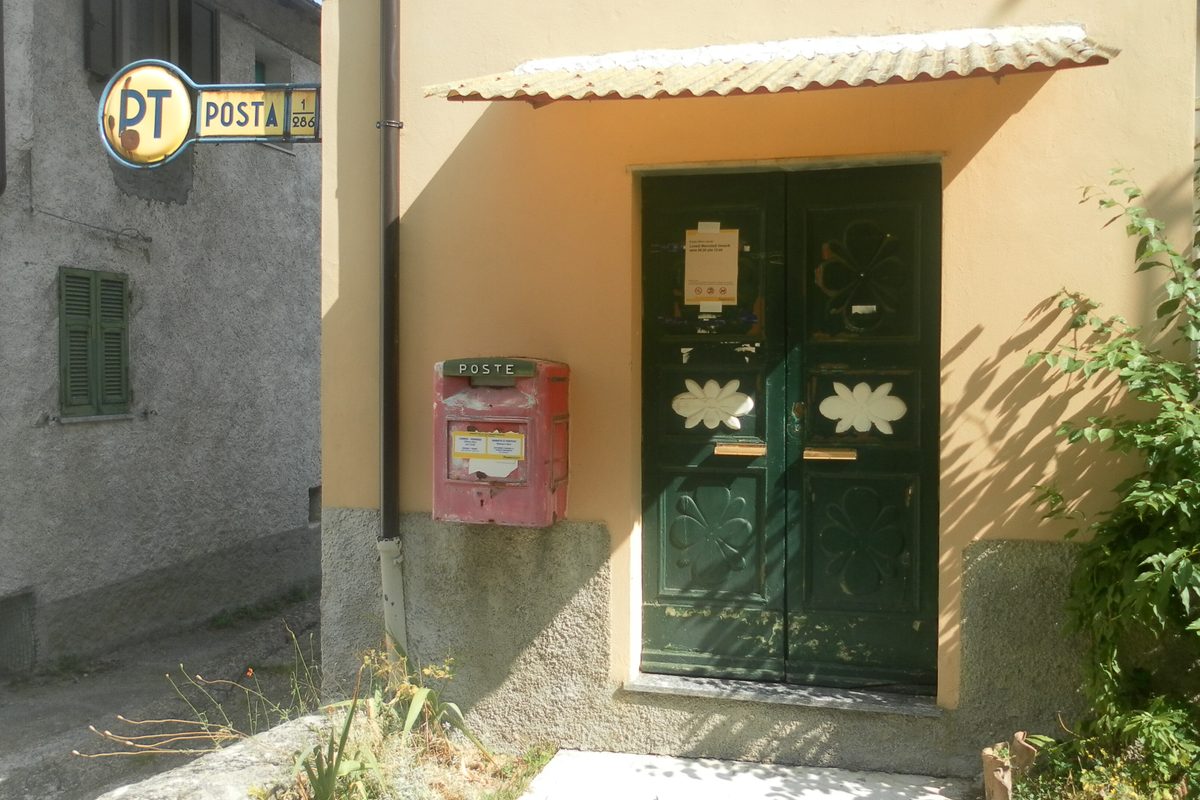 A small post office with a red postbox in a Ligurian village