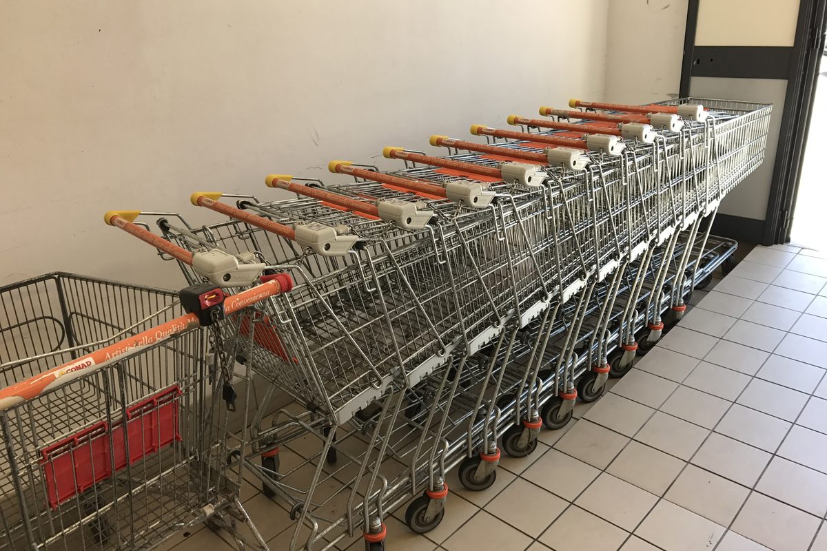 A row of shopping trolleys inside a Conad supermarket in Tempio Pausania