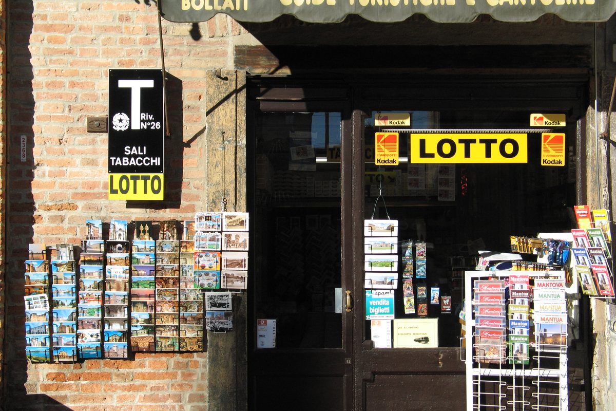 The doorway of a «Sali e Tabacchi» shop in Mantua, with postcards outside and the Lotto sign