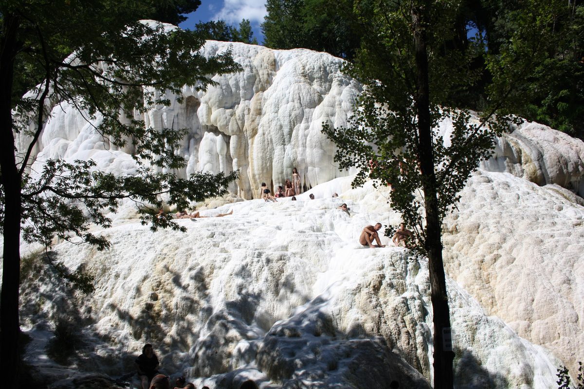 White limestone formations and trees at the hot springs of Bagni San Filippo, near Siena