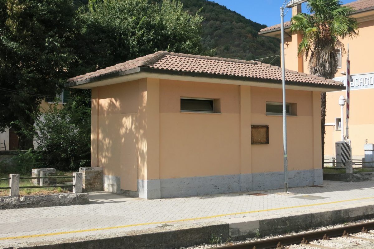 A small public toilet building on the platform of Antrodoco station in Lazio