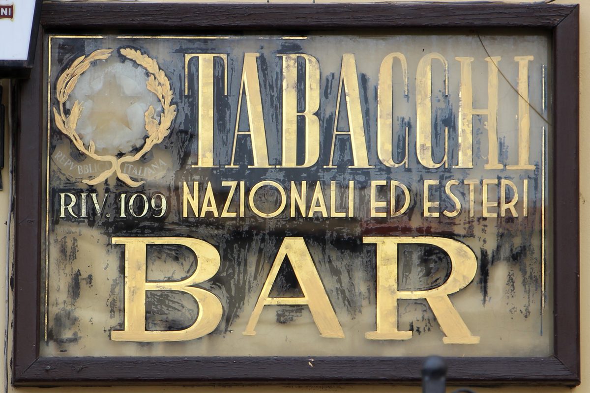 The old painted sign «Tabacchi nazionali ed esteri, Bar» on a corner of Piazza Santa Maria Novella in Florence