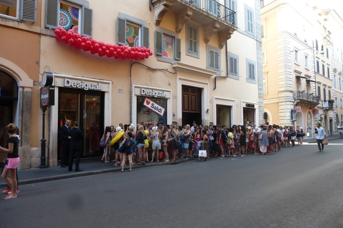 A long queue of shoppers outside a shop on Via del Corso in Rome, early in the morning on the first day of the sales