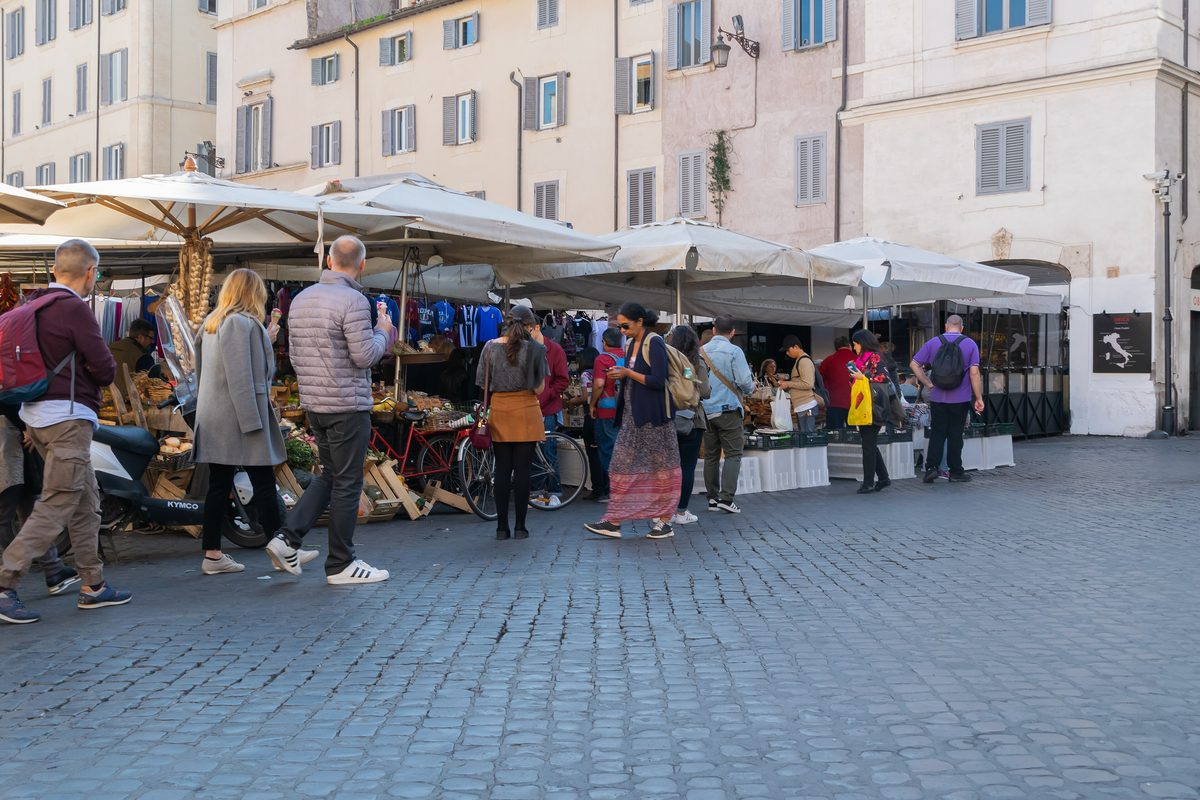 Shoppers among the market stalls of Campo de' Fiori in Rome