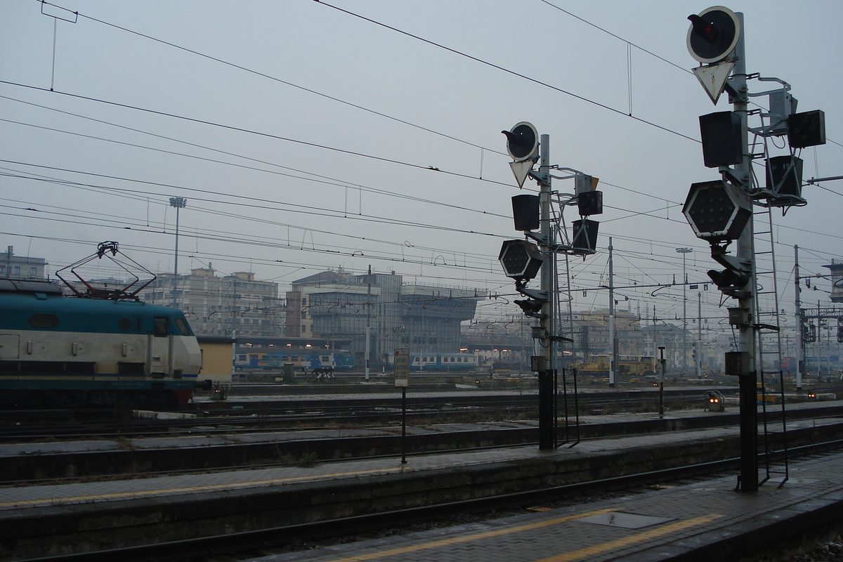 Railway signals and tracks outside Milano Centrale station on a grey morning