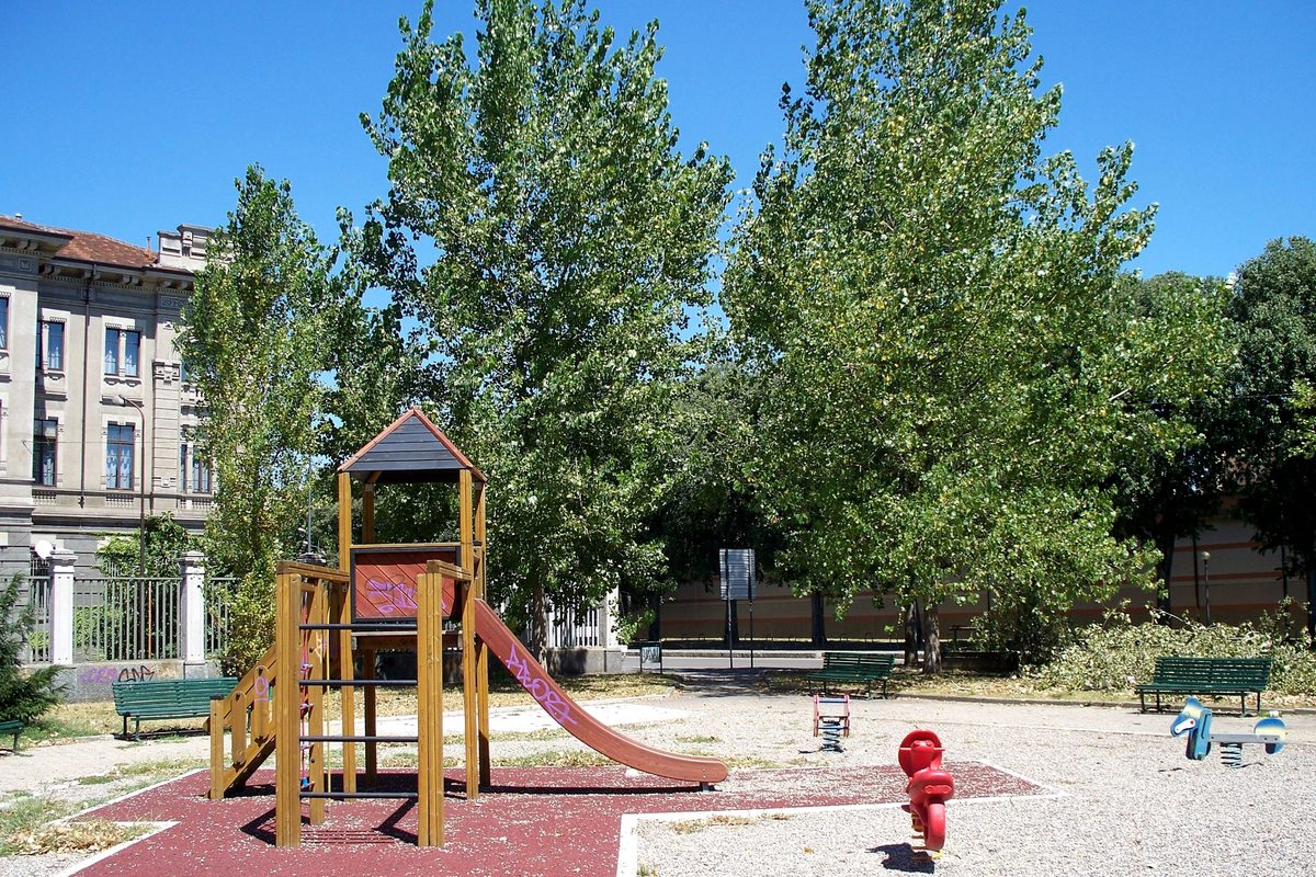 A children's playground with a slide in a park in Milan