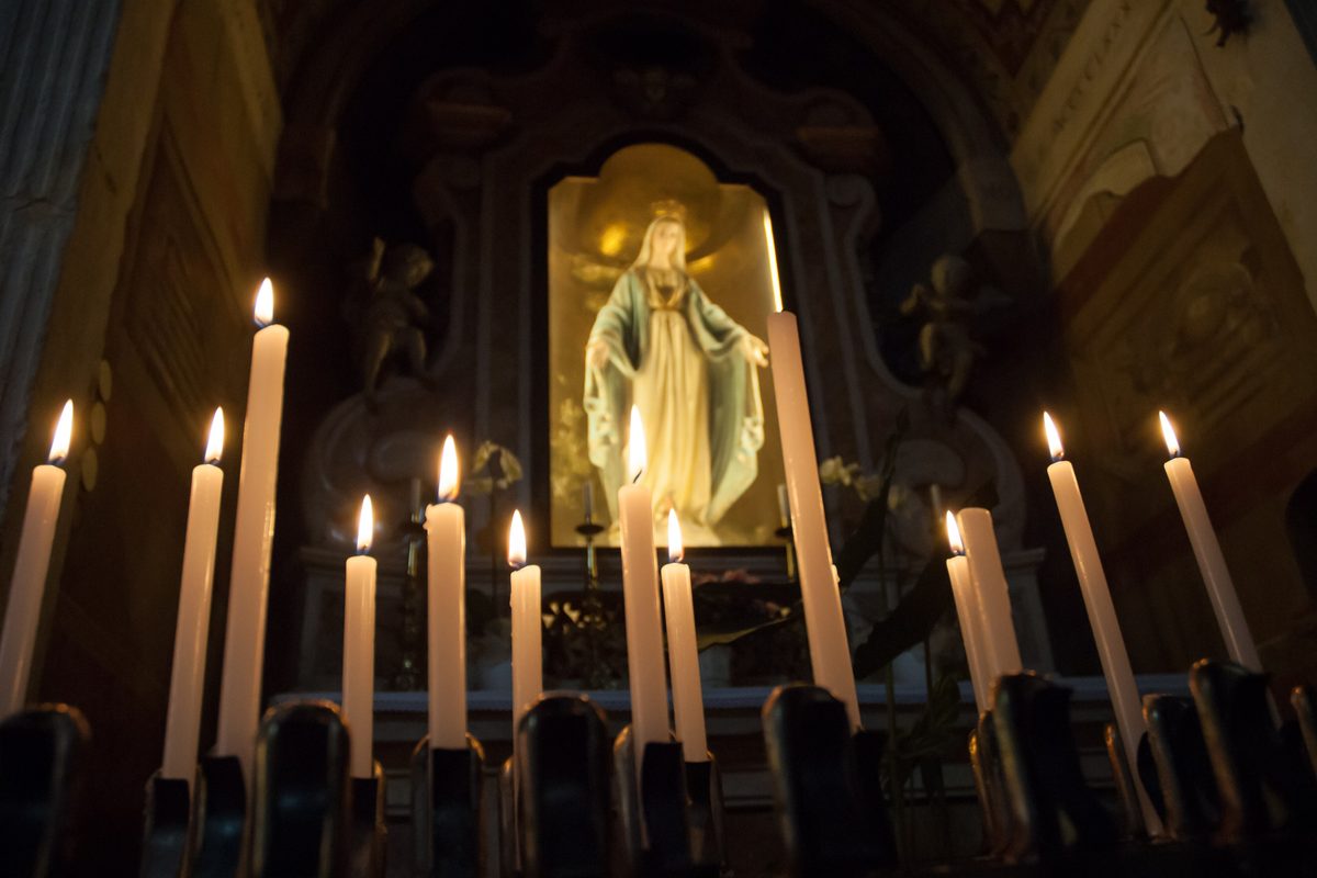 Lit candles in front of the chapel of the Immaculate Conception in San Zeno in Oratorio, Verona